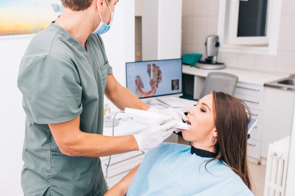 A woman undergoes a dental examination involving X-rays and 3D scans, showcasing the digital transformation in dental diagnostics.