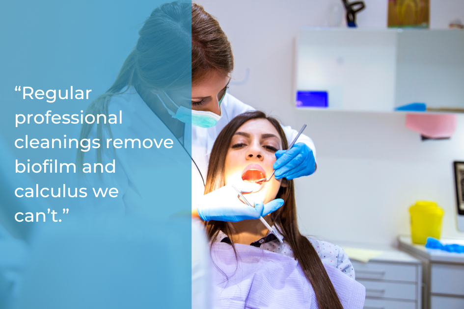 A dental hygienist wearing gloves and a mask cleans a female patient’s teeth in a dental office, with a quote on the left highlighting how often dental cleaning is recommended for optimal oral health.